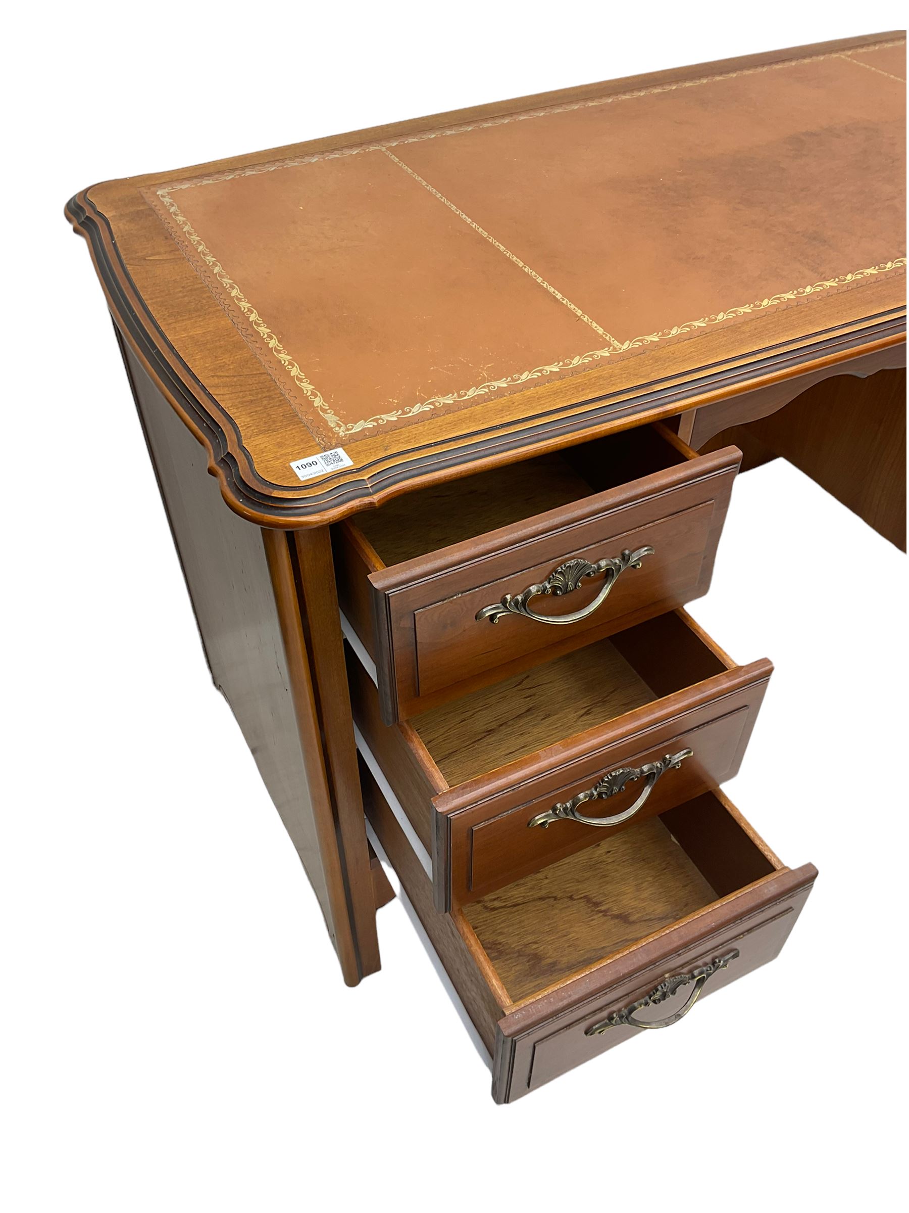 Younger Furniture - cherry wood desk, the shaped top with leather inset, fitted with six drawers