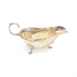 Edwardian silver sauce boat, of typical plain form with shaped rim, with flying C scroll handle and upon three pad feet, hallmarked Birmingham 1907, maker's mark worn and indistinct, together with a pair of Edwardian silver cruets, of urn form, upon three pad feet, hallmarked Horace Woodward & Co Ltd, Birmingham 1905 and a set of six silver apostle spoons, with matching sugar tongs and sugar sifting spoons, some hallmarked Miller Bros, London 1895 and Charles Boynton, all contained within fitted cases