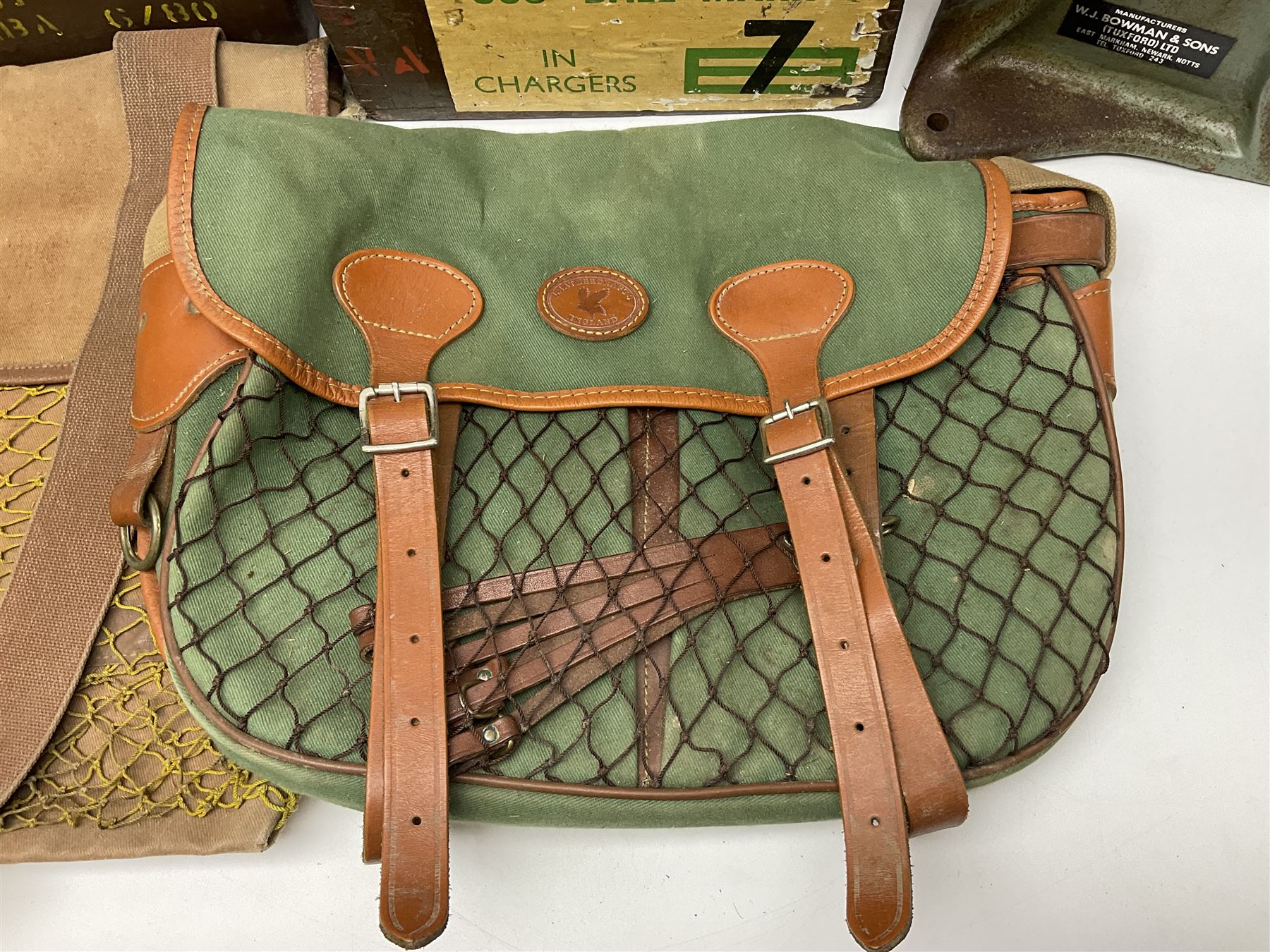 Miscellaneous shooting accessories - W.J. Bowman & Sons clay pigeon launcher; two leather cartridge belts; three cartridge bags; two canvas/leather game bags; and two metal/wooden cartridge boxes