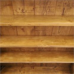 Indigo Furniture - large rustic oak open bookcase, with four adjustable shelves, above a plinth base 