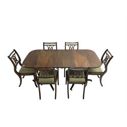 Regency design mahogany twin pedestal dining table, rectangular top with reeded edge, acanthus carved turned column terminating in reeded tripod base with hairy paw feet and castors (W172cm D92cm H75cm) and set eight (6+2) Regency design mahogany dining chairs, pierced back with scroll design, seat upholstered in patterned laurel green fabric, raised on reeded sabre supports (W48cm H88cm)