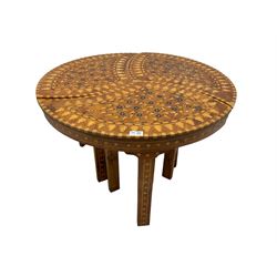 20th century hardwood and marquetry nest of three tables, the three shaped triangular tables fitting together as one circular coffee table, the tops inlaid with ebony and mother of pearl flower heads with parquetry borders, raised on tapered supports