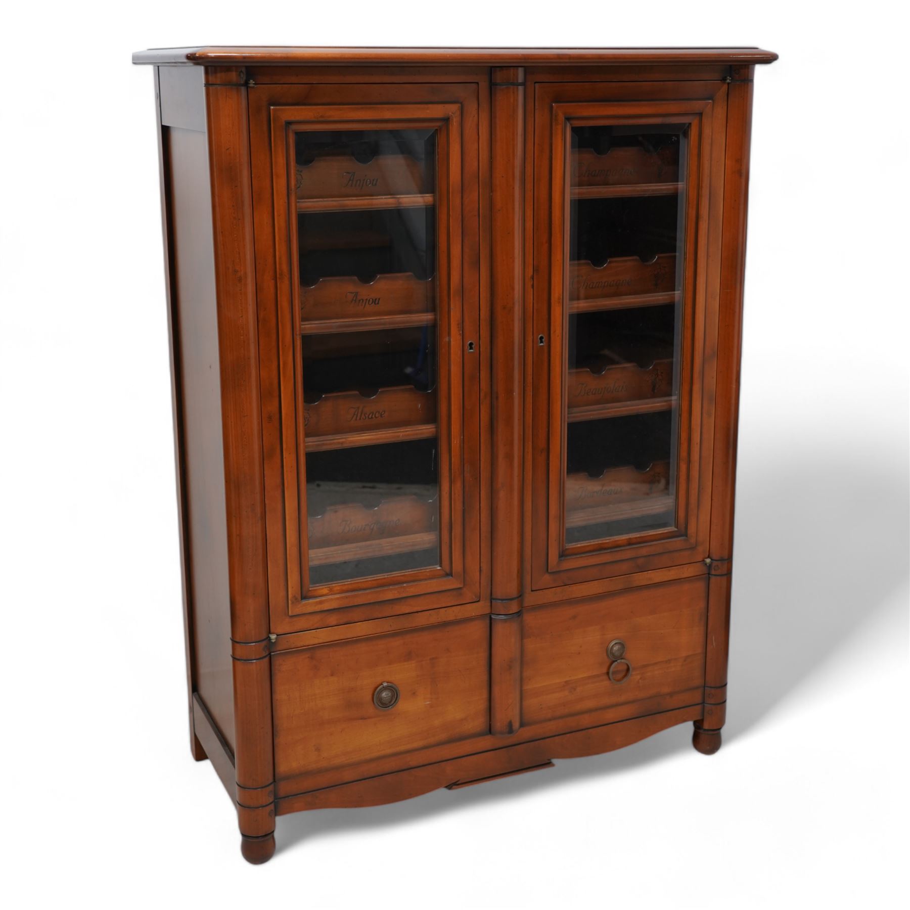 Cherrywood wine rack cabinet, moulded rectangular top over two glazed doors, fitted with eight slides each with three bottle holders inscribed with various wine types, single long drawer to the base 