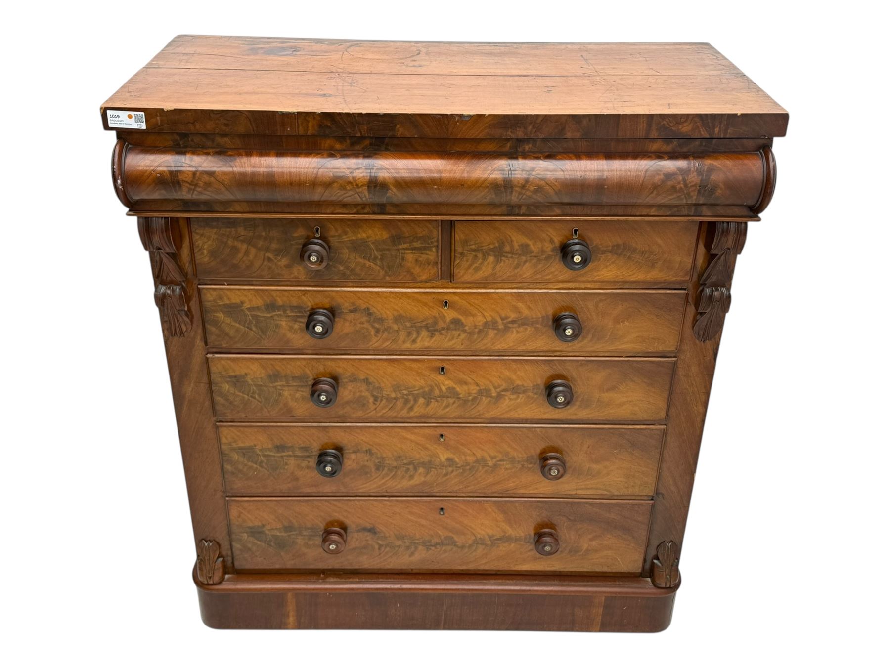 19th century flame mahogany Scotch chest, frieze long drawer above two short and four long graduating drawers, with turned knobs scrolled carved side bracket 