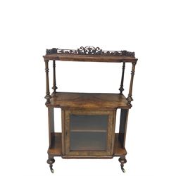 Victorian figured walnut breakfront etagere stand, fretwork gallery back, two tiers with figured book matched veneers over single glazed cabinet, turned feet with brass and ceramic castors 