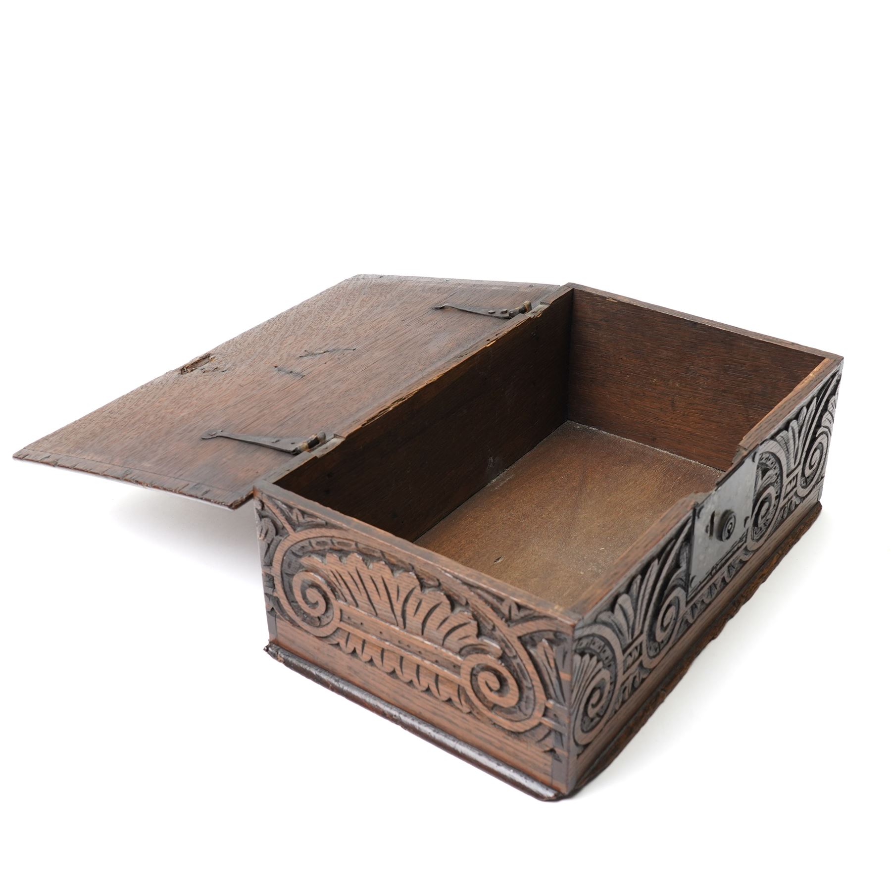 18th century oak desk box with plain hinged lid, the sides and front carved with stylised leaves and scrolls 40cm x 24cm x 14cm