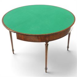 Georgian mahogany demi-lune card table, the lunette shaped top with cross-banded and boxwood-strung edge, opening to reveal baize-lined interior and supported by rear gatelegs, over a banded frieze with applied oval plaques, raised on turned and tapering supports