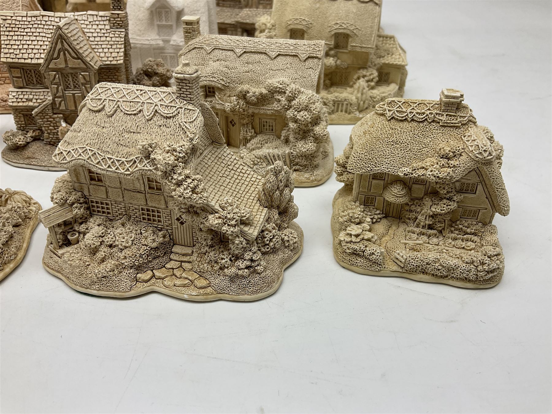 Twenty-three Lilliput Lane models from the Paint Your Own collection, to include Catmint Cottage, Sugar and Spice, Gypsy Cottage, Ruby Cottage and Little Birch, some boxed