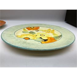 Two 1930s Gray's Pottery plates, both painted with flowers in orange, blue, yellow and green colourway, D27cm