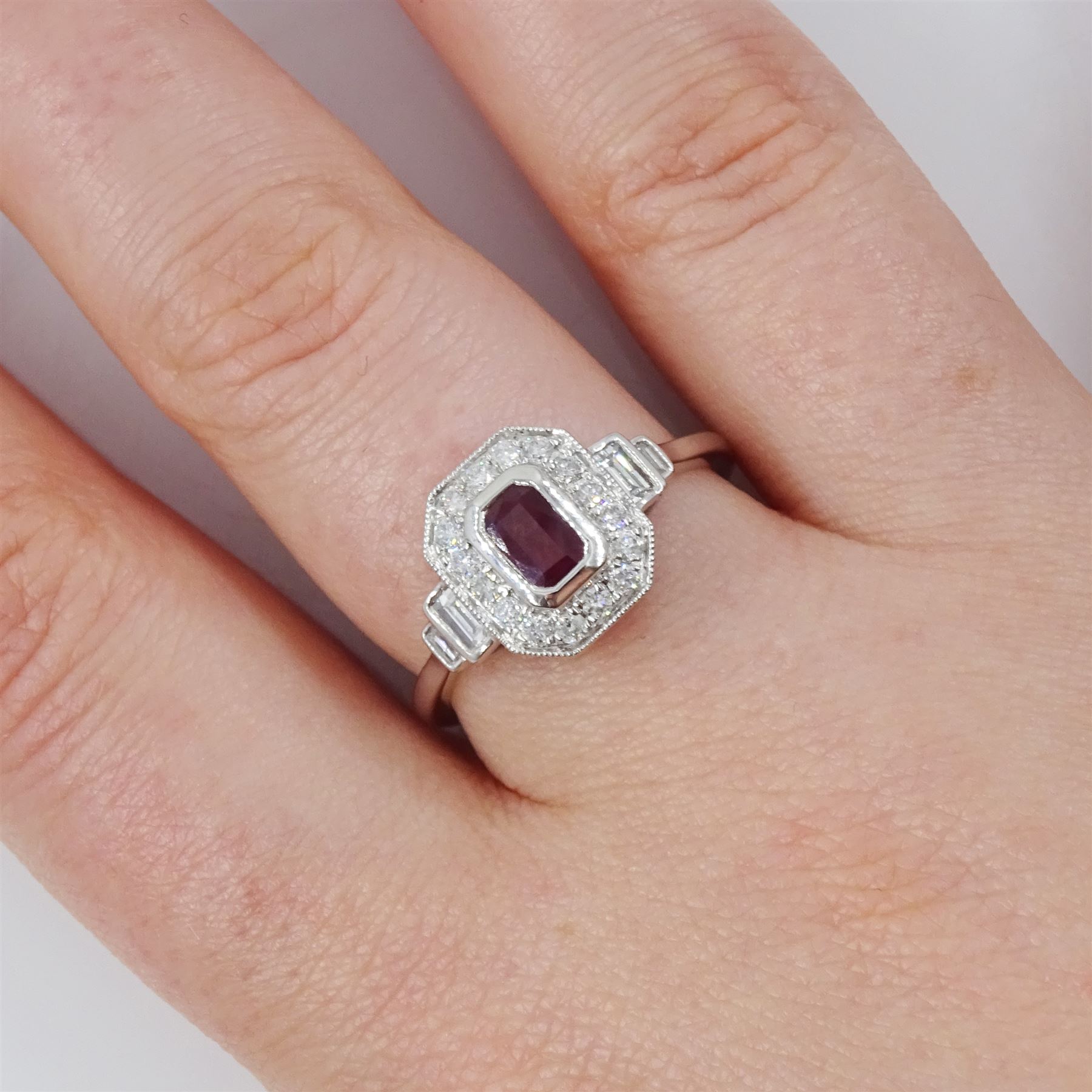 Platinum ruby and diamond ring, single octagonal cut ruby of approx 0.60 carat, with milgrain set round brilliant cut diamond surround and baguette cut diamond shoulders, hallmarked, total diamond weight approx 0.45 carat