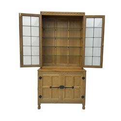 'Mouseman' oak display cabinet on cupboard, raised cabinet enclosed by two lead glazed doors, adzed oak top over double panelled cupboard, fitted with ironwork and carved with mouse signature, by Robert Thompson of Kilburn