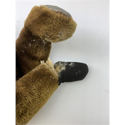 Mid-20th century plush covered teddy bear, the revolving head with applied eyes and stitched nose and mouth, on body with jointed limbs H54cm
