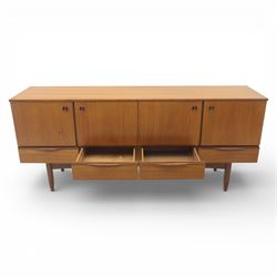 Portwood - Mid 20th century teak sideboard, rectangular top with fall front in the centre flanked by cupboard doors with recessed handles, above four drawers raised on tapered legs