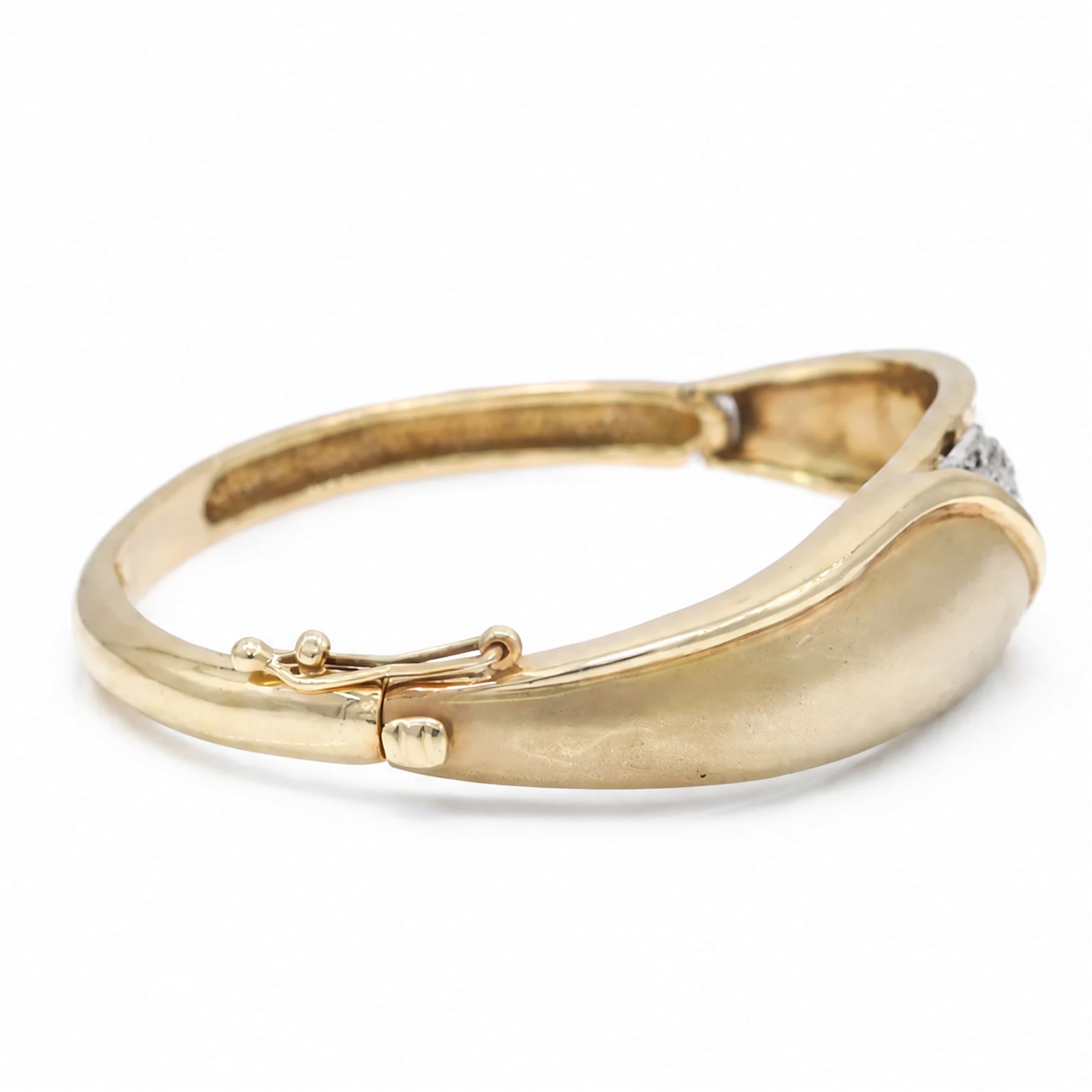 14ct yellow and white gold cubic zirconia abstract design hinged bangle, stamped 585