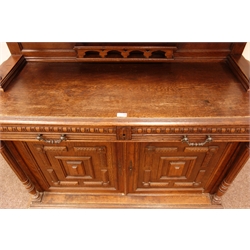  Early 20th century continental carved oak buffet cabinet, raised arched top with intricate carved frieze, door panelling and reeded columns, two drawers above geometric patterned cupboard doors, W140cm, H237cm, D52cm  