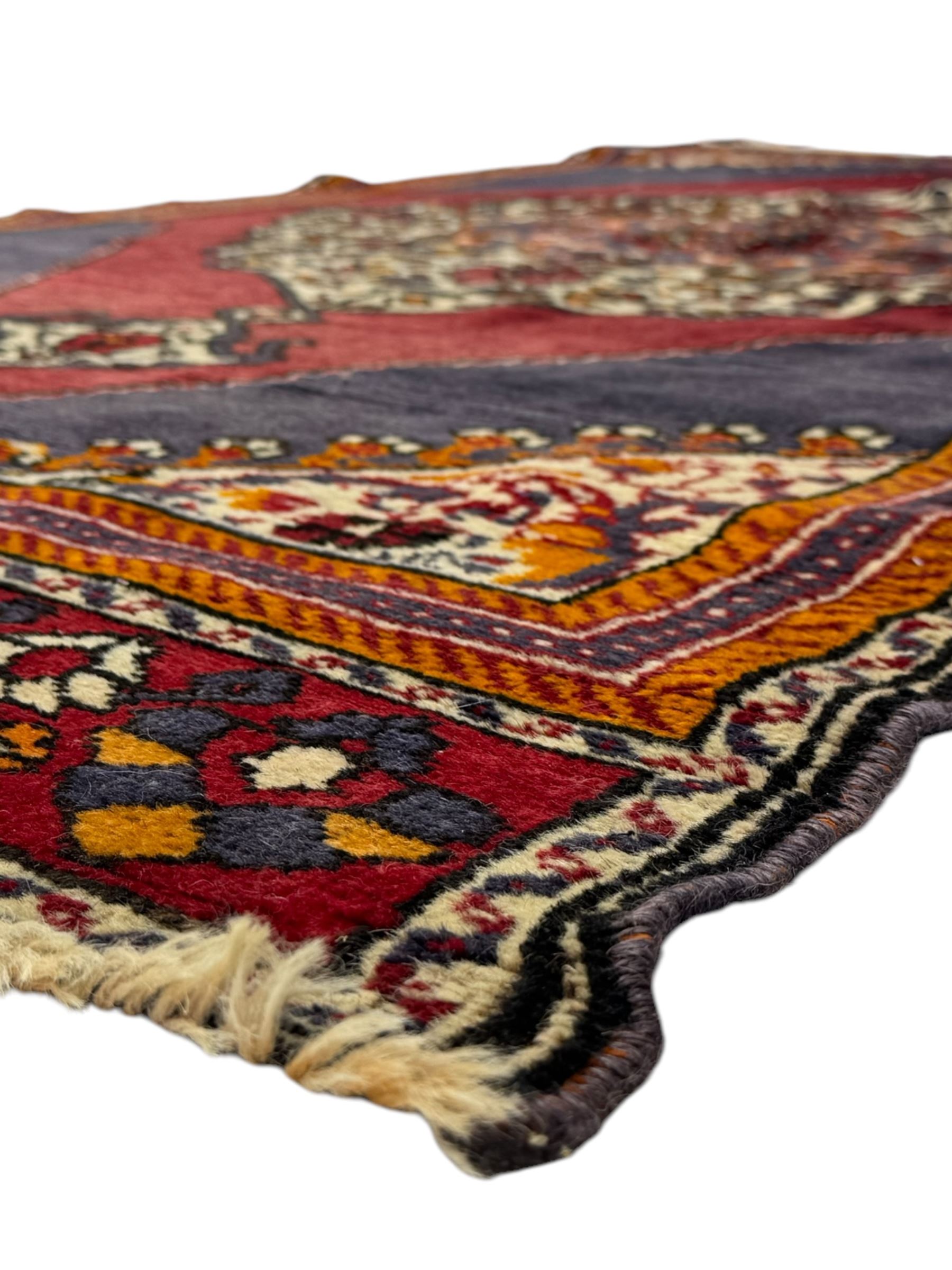 West Persian Hamadan rug, hand knotted, central medallion bordered by geometric and intricate floral motifs, displaying red cream and indigo colours with an orange coloured border  