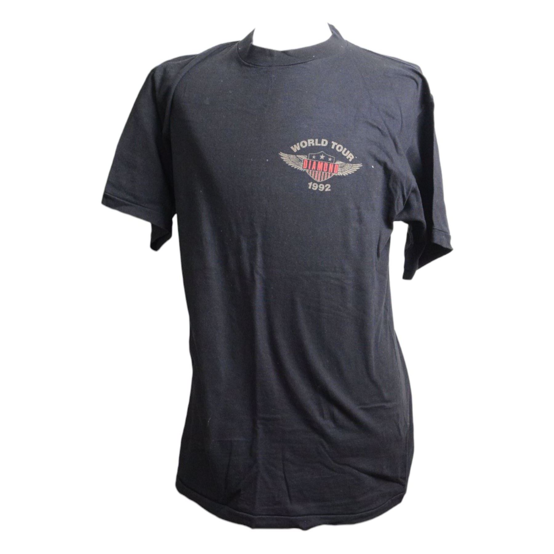 Neil Diamond tour memorabilia, including five t-shirts, cap, programmes, calendar and biography, together with a Neil Diamond In Concert poster, framed