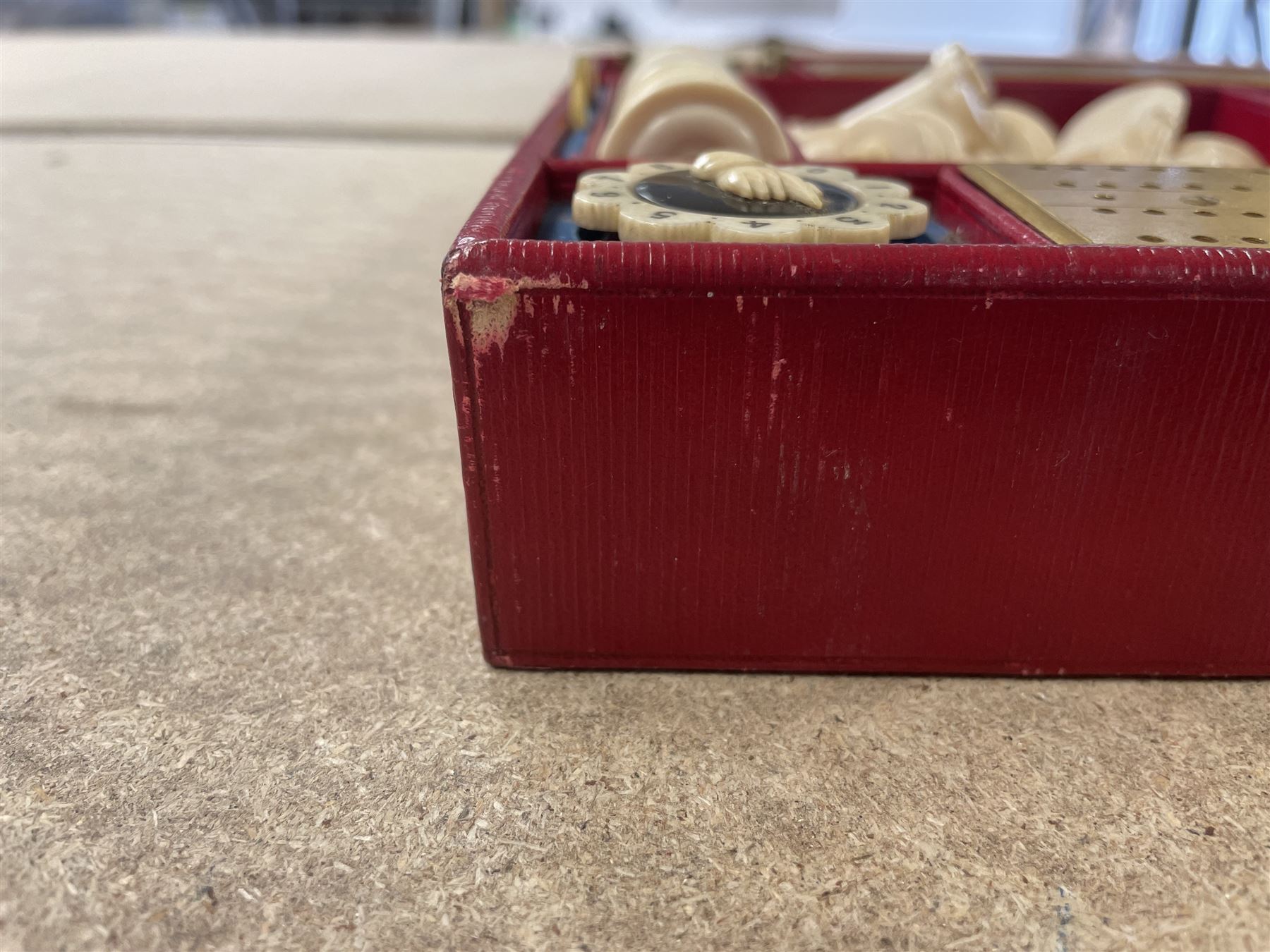 19th century walnut and brass bound games compendium box, painted to enhance the grain, of rectangular form, the hinged opening cover with rounded sides, central brass cartouche with engraved lion crest, and brass riveted straps, opening to reveal a red leather and blue silk lined compartmented interior, with fold-down games board, and lift-out tray containing playing cards, ebony turned dice towers, white and red stained bone draughts, and chess pieces, ivory dice, and ivory and ebony whist markers, and brass bezique board, cribbage board and markers, H15cm W32cm D24cm
This lot has been registered for sale under Section 10 of the APHA Ivory Act