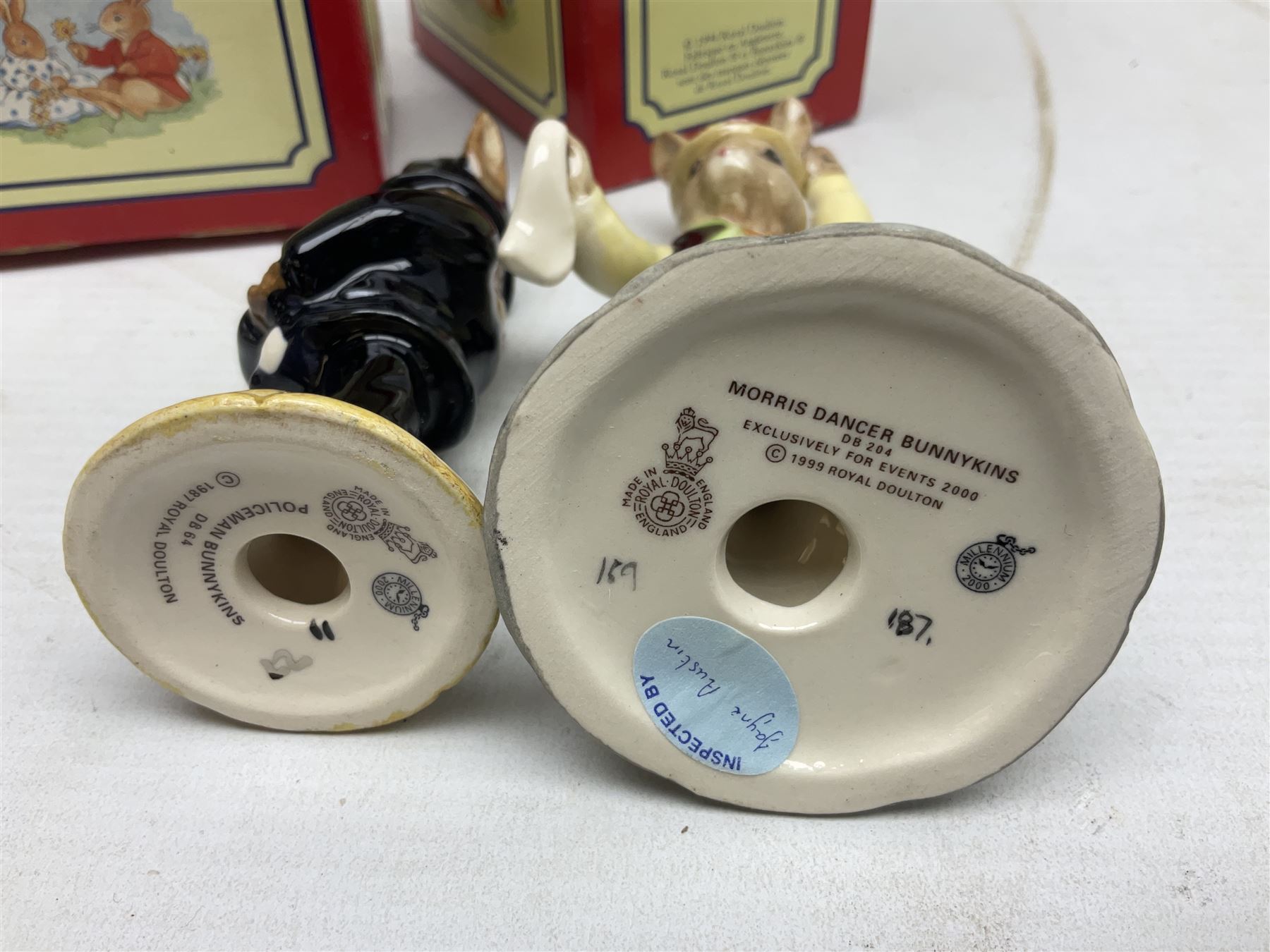 Royal Doulton The Mickey Mouse Collection Pluto figure, Coalport Characters The Snowman Dressing Up figure, three Royal Doulton Bunnykins figures comprising Policeman, Morris Danger and Eskimo, and display stand, Royal Doulton John Beswick Tiggy Winkle, Royal Albert Beatrix Potter Peter Postbag and three Goebel Hummel figures, all boxed