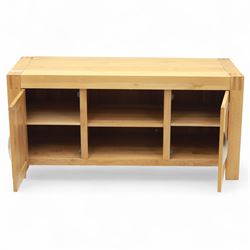 Contemporary solid oak television stand, rectangular top over an open central section with adjustable shelf, flanked by cupboard doors with vertical recessed panel fronts and brushed steel handles, on block feet