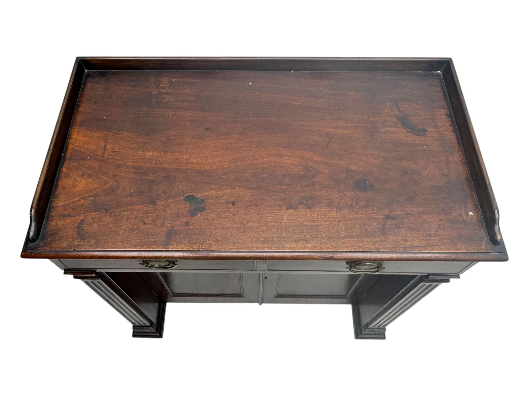 George III mahogany chiffonier or side cabinet, rectangular top with raised gallery and two frieze drawers, over double cupboard enclosing shelves, fluted side supports, raised on castors