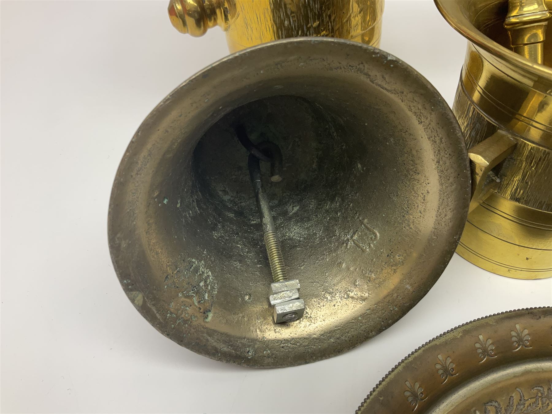 Four brass pestle and mortars, to include two miniature examples, together with other brassware including four branch candleabra, bells etc