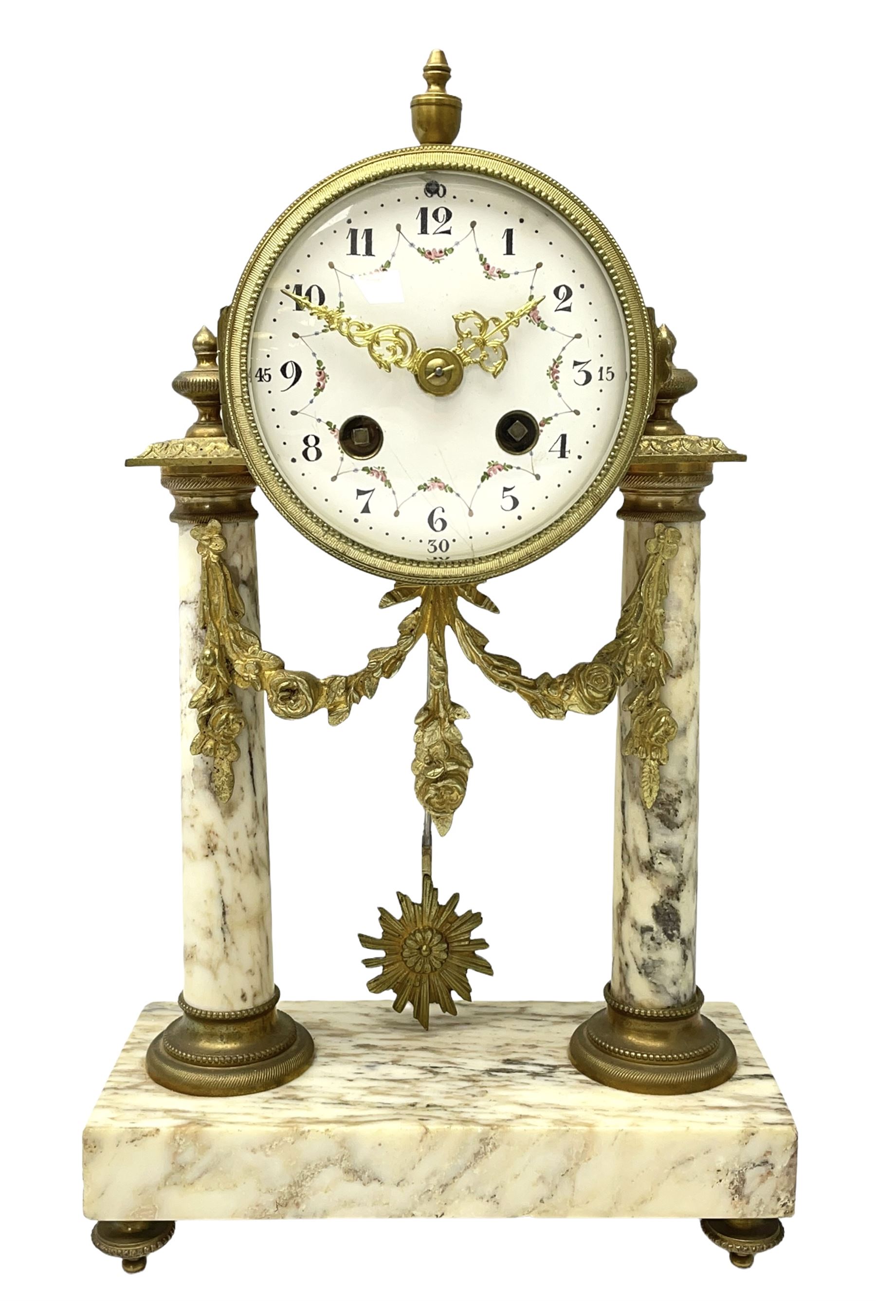 20th century French portico clock c1910 on a white veined marble base, gilt drum movement case supported between two marble columns with brass capitals and a suspended garland swag with a starburst pendulum beneath, enamel dial with Arabic numerals, floral decoration and Louis XV pierced gilt hands, convex glass and brass bezel, 8-day countwheel striking movement striking the hours and half hours on a bell. 




