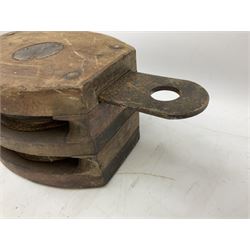Three ship pulleys comprising wooden block double with stiff swivel hook, wooden block triple with swivel eye and wooden block with swivel eye, largest example L49cm