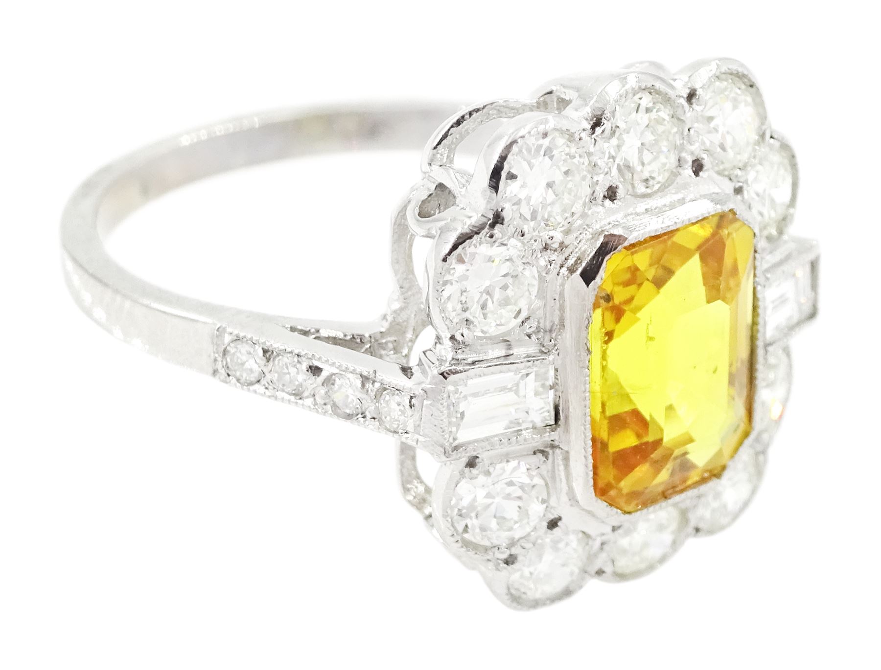Platinum yellow sapphire and diamond milgrain set cluster ring, single octagonal cut sapphire of approx 2.20 carat, surrounded by two baguette cut diamonds and ten transitional cut diamonds and diamond set shoulders, stamped Plat, total diamond weight approx 0.95 carat