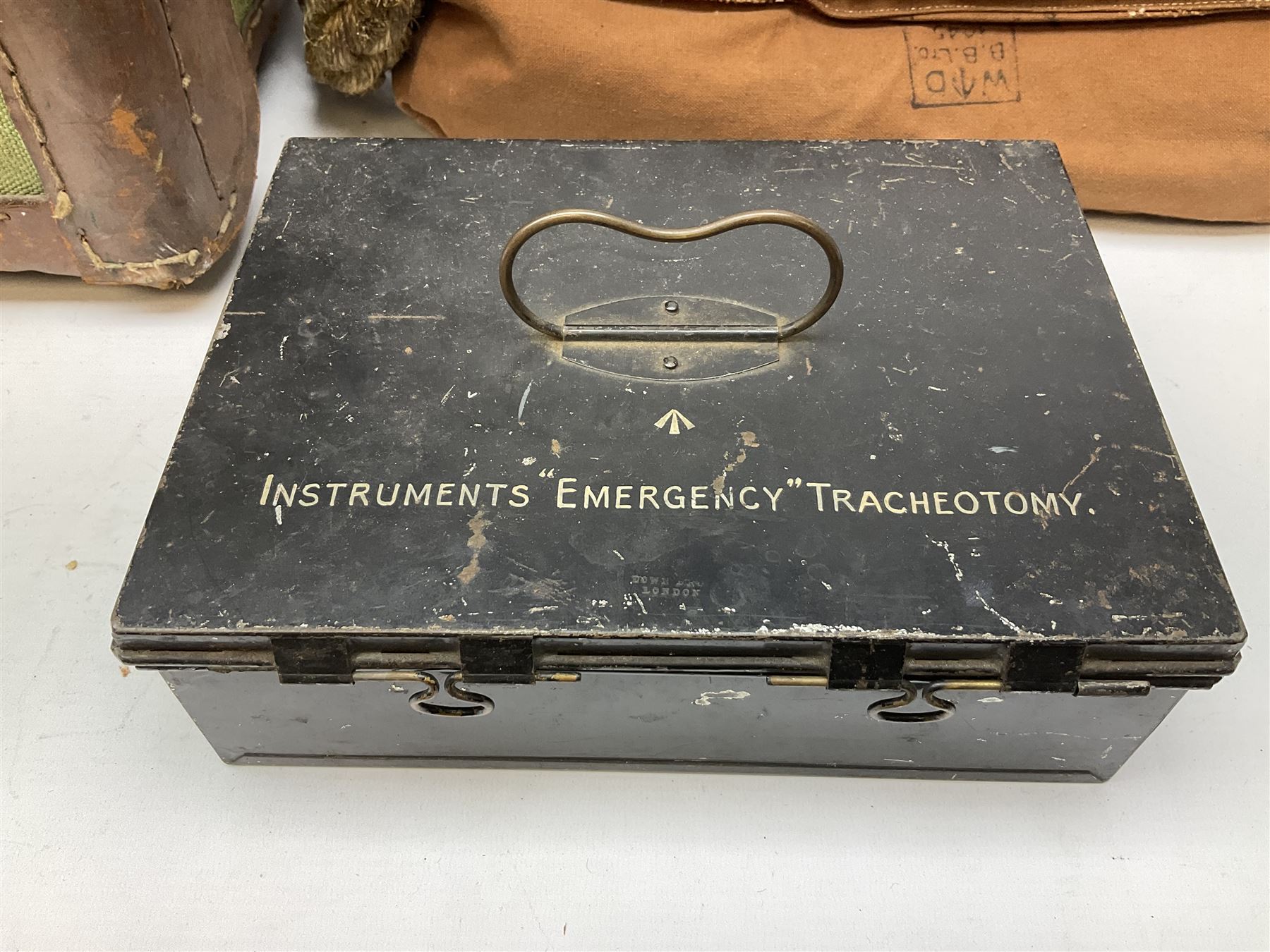 WW2 British Army RAMC 'Regimental Medical Pannier', well marked externally and dated 1941, stamped May 1943 internally, canvas covered wicker form with leather edges, hinged top and fall front with two rope carrying handles, fitted iron locking straps with securing chains; contains various unused field dressings and bandages with WW2 dates and two pillows; original label under lid L79cm