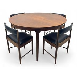 Mid-20th century teak extending dining table, circular top with pull-out extension and concealed leaf extension mechanism, on tapered supports; set of four teak dining chairs with black vinyl padded seats 