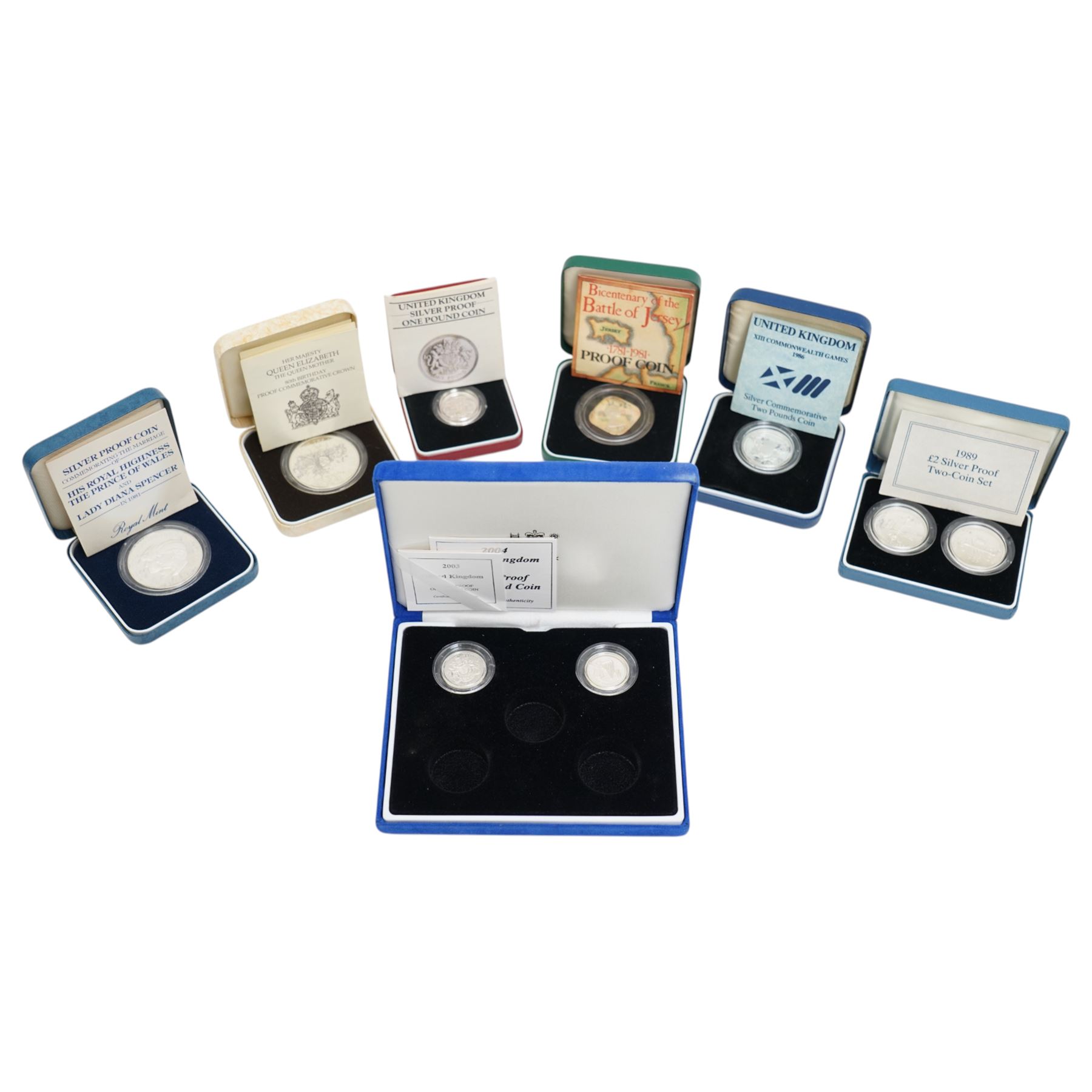 Six The Royal Mint United Kingdom silver proof coins or sets, comprising 1980 crown, 1981 crown, 1981 Jersey one pound, 1983 one pound, 1986 two pound, 1898 two pound two coin set, all cased with certificates, together with two further silver proof one pound coins, 2003 and 2004, encapsulated with certificates
