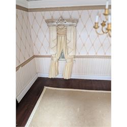 Two modern three storey dolls houses, each painted green with decorated interiors, both upon a single white wooden base, together with a large collection of dolls house furniture, accessories and figures 