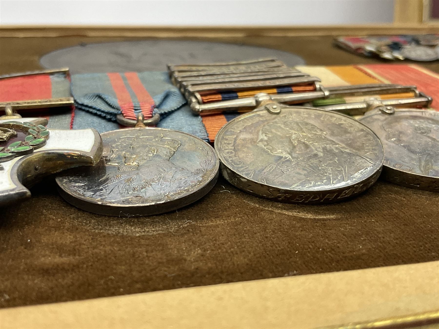 KIA (Ypres)  DSO group of eight Boer War/WW1 medals comprising Victorian DSO, Queens South Africa Medal with six clasps for Belmont, Modder River, Driefontein, Johannesburg, Diamond Hill and Belfast, Kings South Africa Medal with two clasps for South Africa 1901 and South Africa 1902, Turkish Liakat Medal, WW1 1914 Star with 5th Aug - 22nd Nov 1914 bar, British War Medal and Victory Medal and George V 1911 Coronation Medal, awarded to Lieutenant (later Captain) Albert Alexander Leslie Stephen Scots Guards; the group of six Boer War miniatures including additional Turkish Order of the Medjedie 3rd Class with rosette; all with ribbons and later mounted and framed with his bronze memorial plaque; together with Cecil Cutler (active 1886-1934) heightened watercolour three-quarter length portrait of Stephen in uniform, signed and dated 1915, 52 x 35cm; gilt frame;
Auctioneer's note: STEPHEN, ALBERT ALEXANDER LESLIE, Lieutenant, was born 3rd February 1879, son of Major J Z Stephen and Augusta Henrietta Mary (nee Ricketts). He was educated at Eton, and joined the Scots Guards 4th January 1899, becoming Lieutenant 4th April 1900. He served in the South African War, in which he was present at a large number of engagements. He took part in the advance on Kimberley, with the action at Behnont, and was present at Enslin, Modder River and Magersfontein, and also at the operations in the Orange Free State, Transvaal, Orange River Colony and Cape Colony, including actions at Poplar Grove, Driefontein, Vet and Zand Rivers; the action near Johannesburg, those at Pretoria, Diamond Hill and Belfast. From January 1901, he was Assistant Provost-Marshal to Pulteney's Column, and he was Intelligence Officer to Garrett's Column in 1902. He was twice mentioned in Despatches [London Gazette, 10 September 1901, and 29 July 1902]; received the Queen's Medal with six clasps; the King's Medal with two clasps, and was created a Companion of the Distinguished Service Order [London Gazette, 31st October 1902]: 