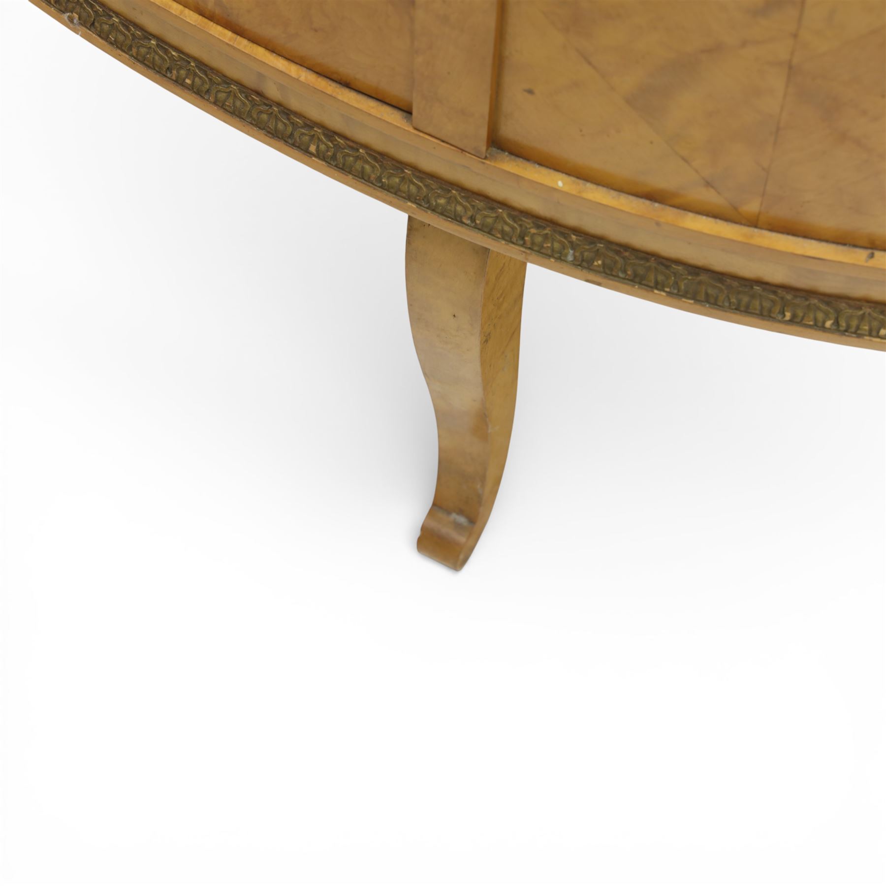 Edwardian satin walnut display cabinet, bowed oval form with moulded and dentil cornice over glazed panels, enclosing a laurel wreath damask interior with adjustable glass shelves, the frame applied with gilt metal bead mouldings and mask mounts, enclosing a shelved interior, raised on cabriole supports with moulded feet