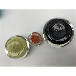 Three millefiori paperweights, together with a green glass dump paperweight with air bubble inclusions, Caithness Daisy and Cauldron paperweights and two small Caithness glass vases, tallest H9cm
