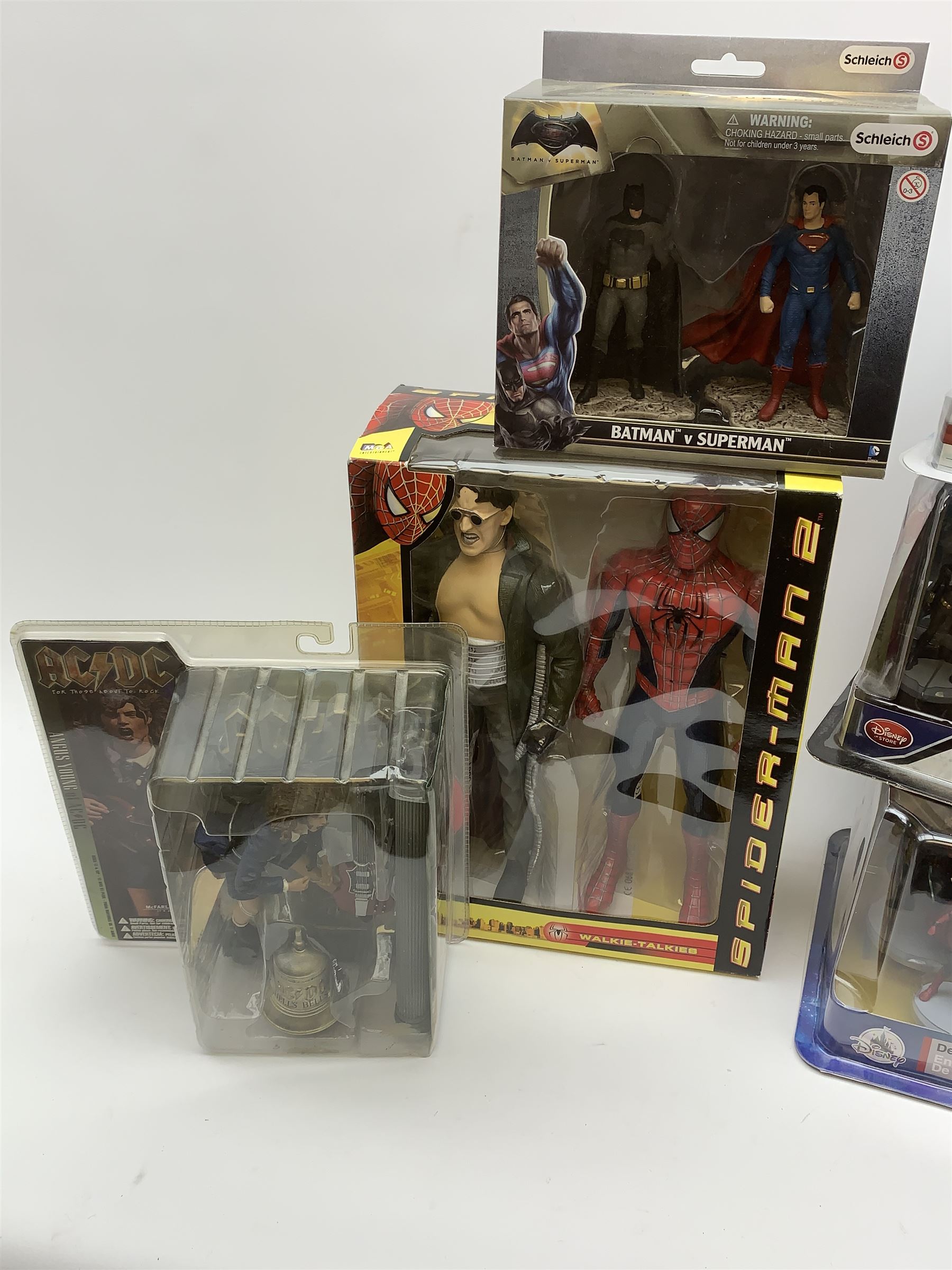 Three Disney Store Marvel Avengers Deluxe Figurine Sets; Spiderman Walkie-Talkie Set; Schleich Batman v Superman action figure Set; and Angus Young of AC/DC action figure; all appear mint in unopened boxes (6)