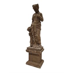 Hand carved stone Neoclassical figure of the Roman goddess Flora, her hair pinned with roses, draped in a toga, holding a basket of flowers in her right hand, raised on a stepped square plinth base 