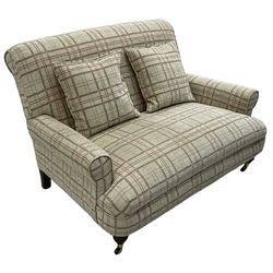 Traditionally shaped two-seat sofa, rolled back and arms, upholstered in checkered fabric, on turned front supports with brass cups and castors 