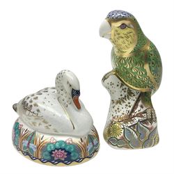 Two Royal Crown Derby paperweights, comprising Amazon Green Parrot, limited edition 1639/2500, with gold stopper and White Swan, with silver stopper, both with printed mark beneath and original box