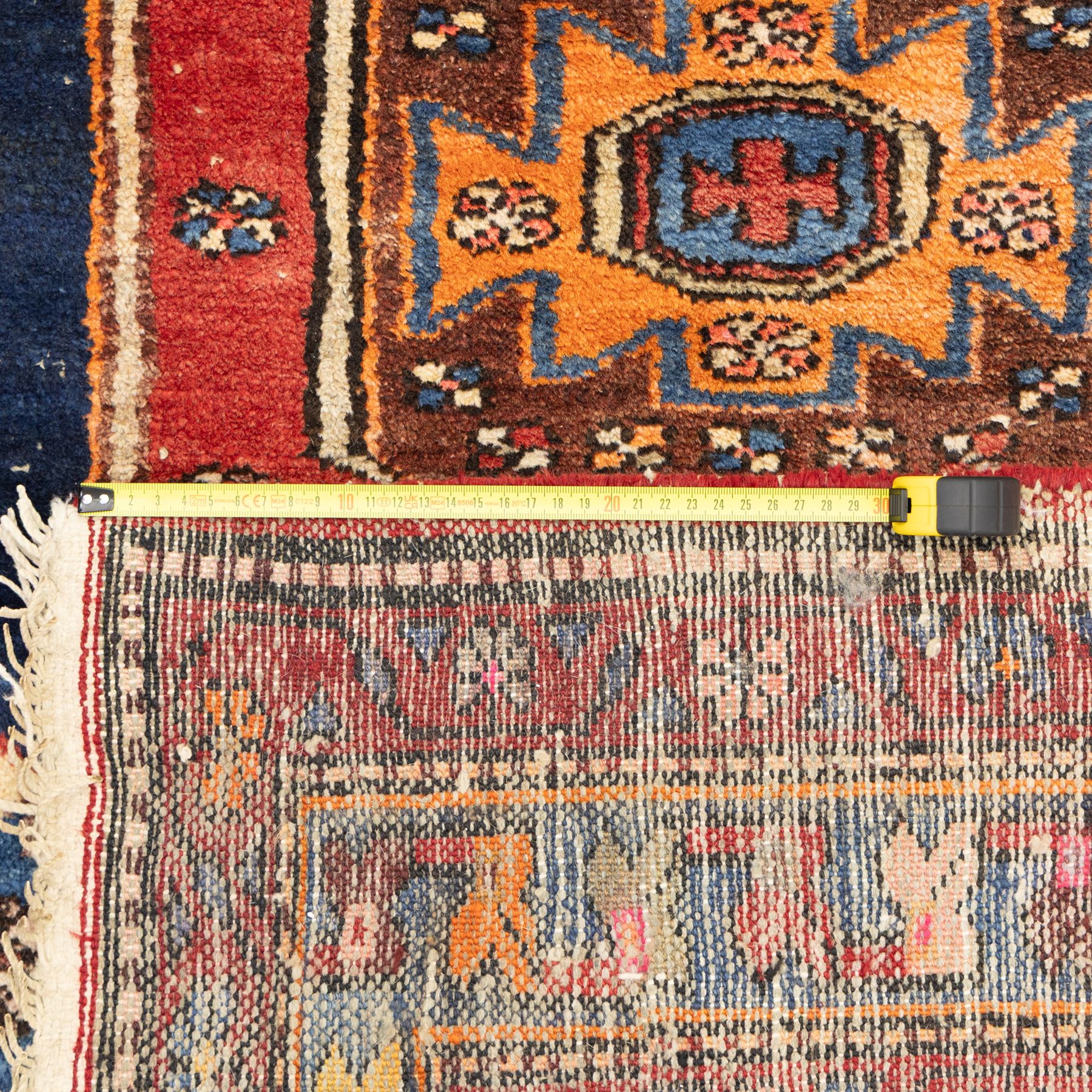 Persian Qashqai rug, wool on cotton foundation, triple stepped lozenge medallions with stylised motifs on a blue ground, within floral and geometric borders in rich red and cream
