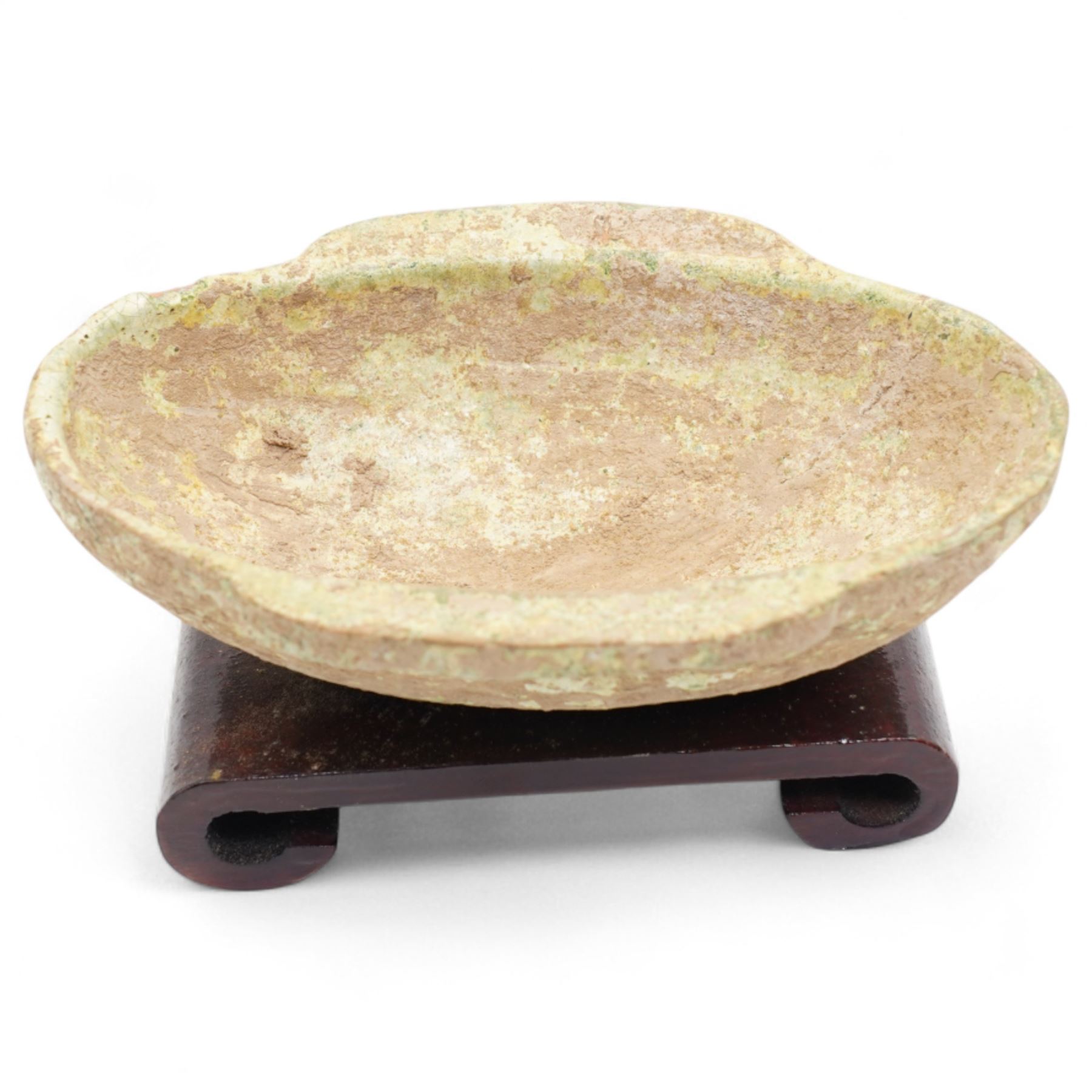 Two small Chinese terracotta 'ear' shaped wine cups, probably Western Han Dynasty c.206BC-24AD, one with green glaze, each on hardwood stand, W12cm (2)