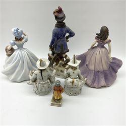 Pair of Sitzendorf figures modelled as Oriental male and female fruit sellers H15.5cm, two coalport figurines Lavender Walk and Christina H22cm, continental figure of Russ Kosaken Leutn H27cm and a girl with a basket H10cm. 
