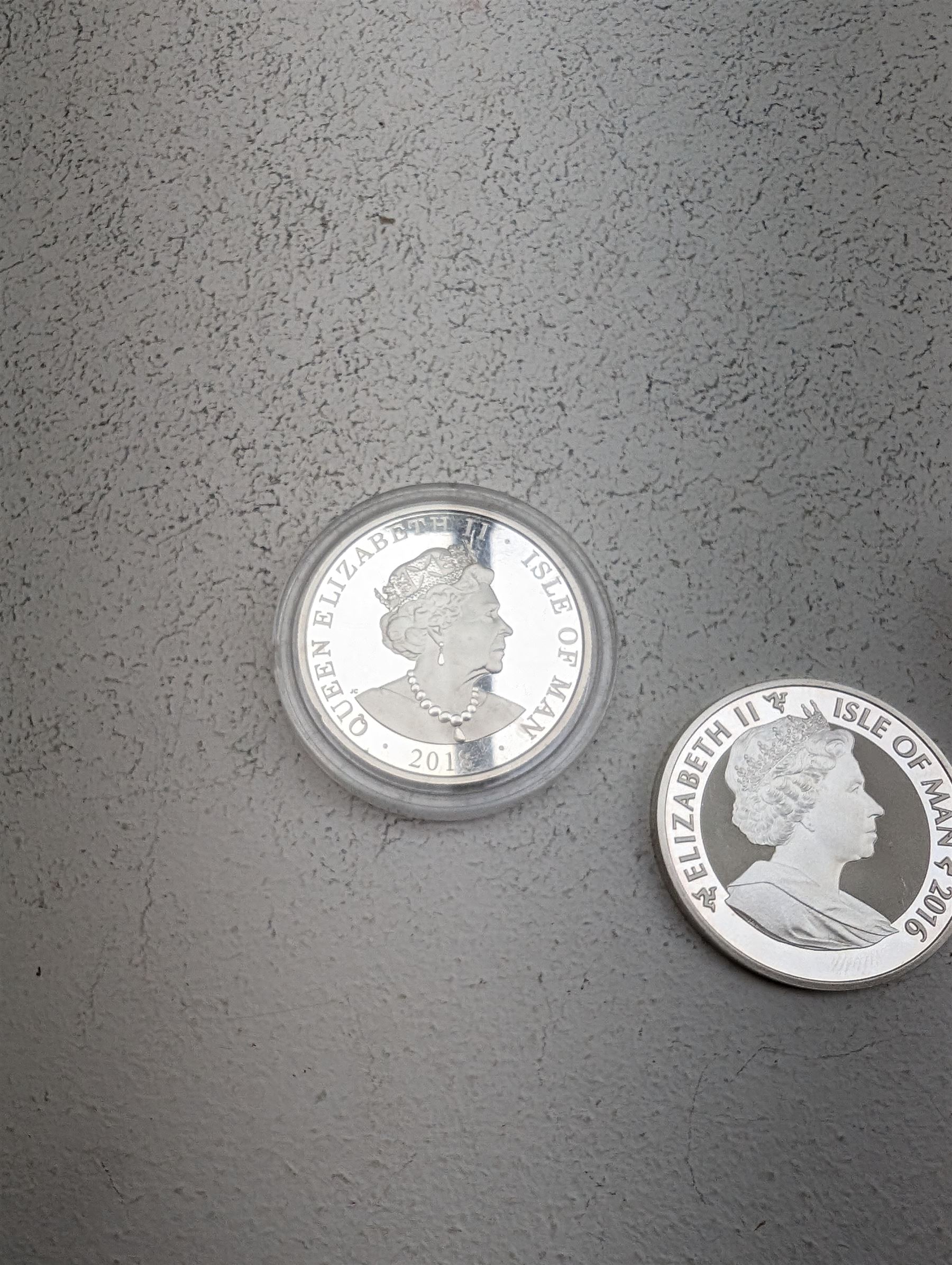 Three Queen Elizabeth II Isle of Man one ounce fine silver coins, comprising 2016, 2018 one angels and 2018 one noble 