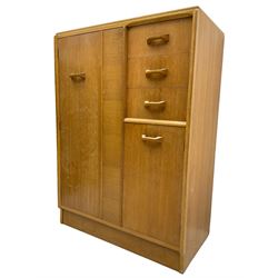 G-Plan - mid 20th century teak tallboy or combination wardrobe, left side with full-height hanging cupboard, right side with three drawers, the top fitted with vanity mirror, above cupboard with shelves, raised on a plinth base