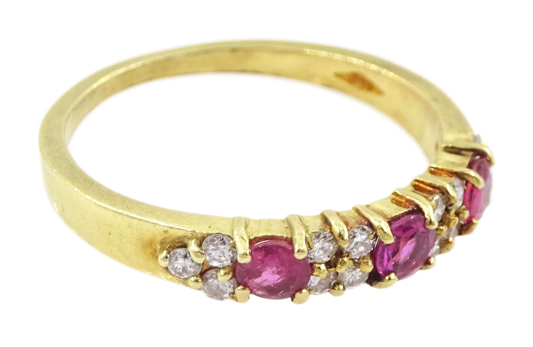 18ct gold three stone round cut ruby and round brilliant cut diamond ring, London 1991