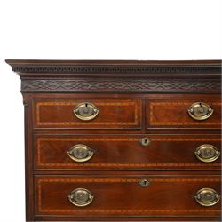  Late 18th century mahogany and inlaid chest on chest, projecting cornice above blind fretwork in laid drawers, the upper chest with two short over three graduating drawers, the lower section with brushing slide over three long graduated drawers, raised on bracket feet