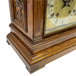 Winterhalder & Hofmeier- German 8-day oak cased mantle clock, in an architectural styled case with a gable pediment and recessed carving to the tympanum, square brass dial flanked by carved reeded pilasters and capitals, with open carved silk backed sound frets on a shaped plinth with padded feet, brass dial with cast spandrels and silvered chapter, Roman numerals, minute track and stylised gothic hands, conforming chime/silent and pendulum regulation dials, twin train going barrel movement with quarter-hour striking on two coiled gongs and the hours on one.
With pendulum.