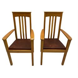 Pair of solid oak Arts and Crafts style carver chairs, inlay to top rail, drop in seat