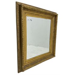 Victorian design gilt wall mirror, the frame decorated with moulded gold foliate patterns, with rectangular bevelled plate